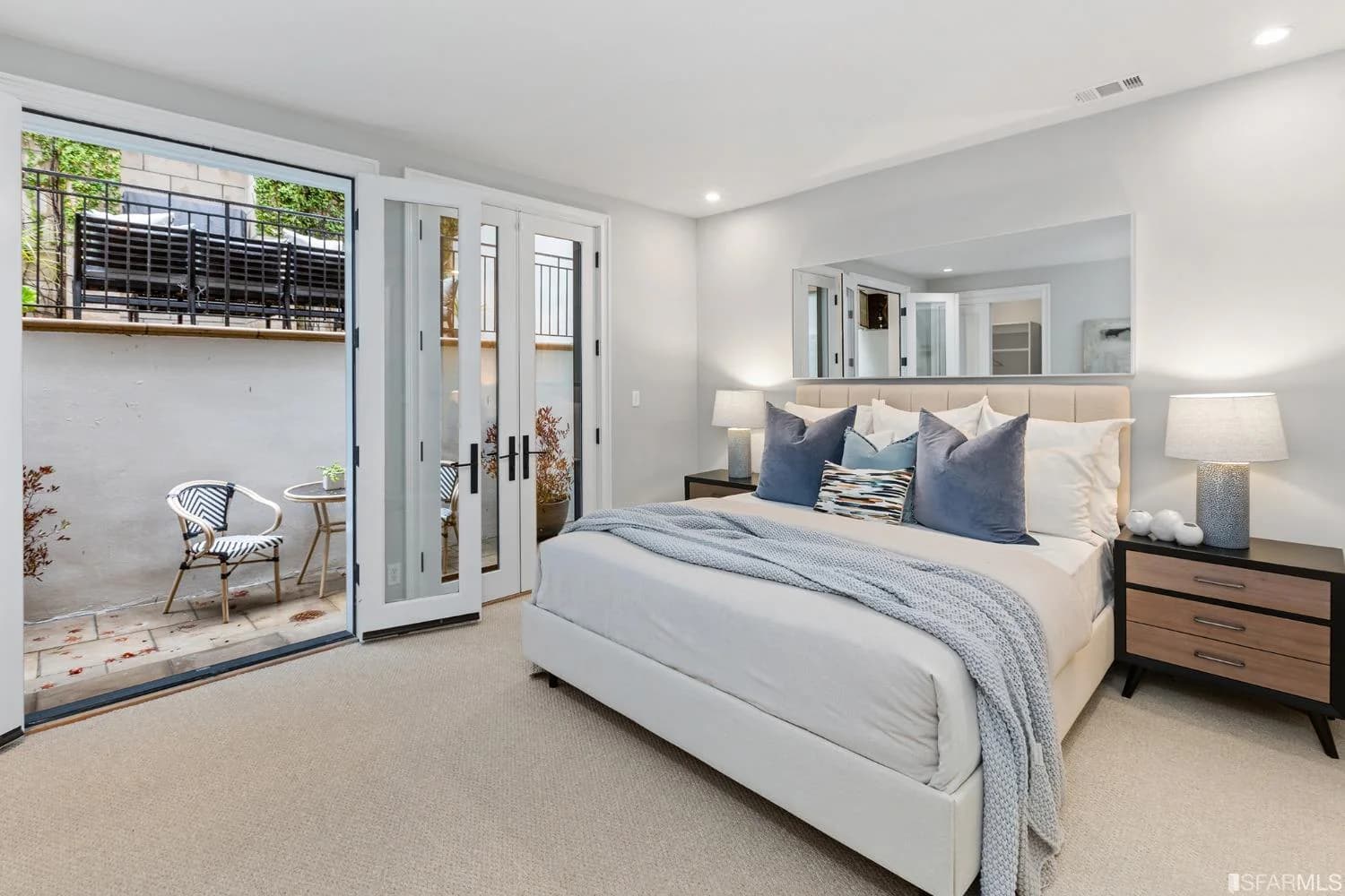 En-suite bedroom with French doors opening directly to a patio