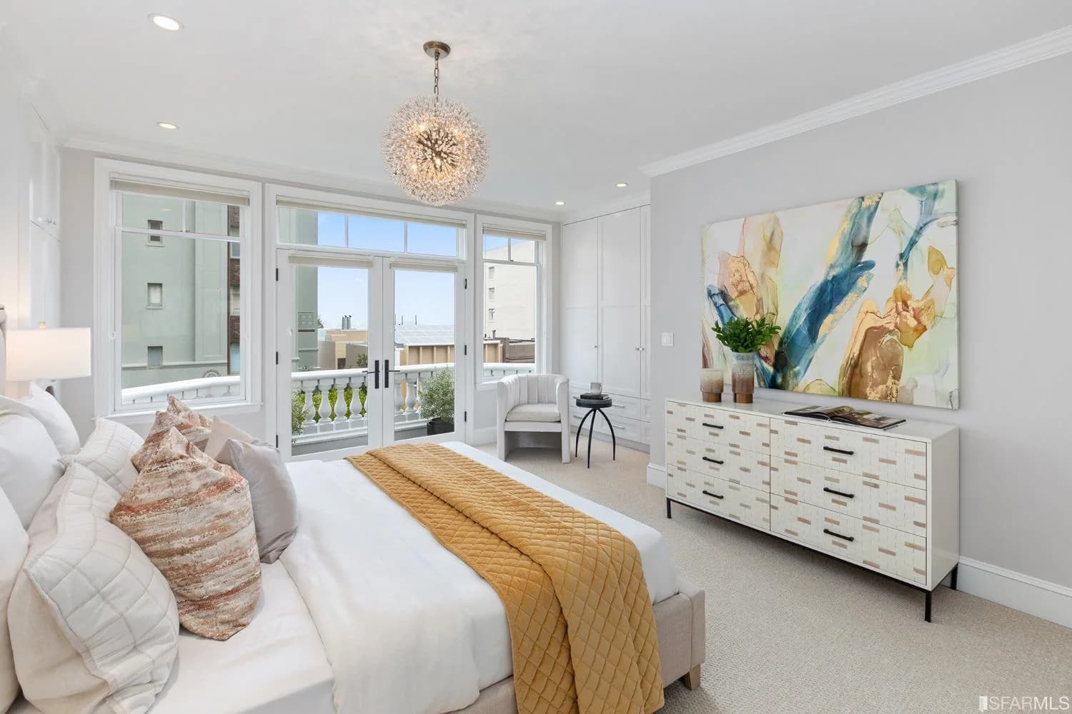 Top-floor primary bedroom with French doors opening toward the balcony